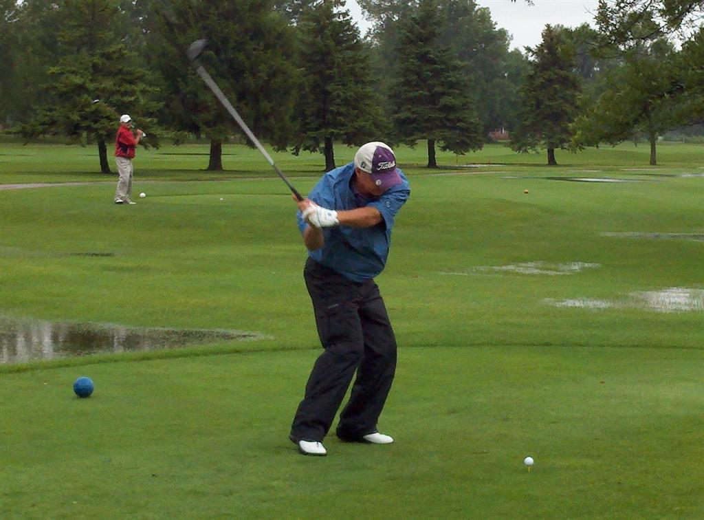 Overall Champion Rick Webb puts a good pass on his tee shot while Tom Rezler looks on.